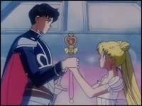 Usagi and Mamoru clasp the Spiral Heart Moon Rod